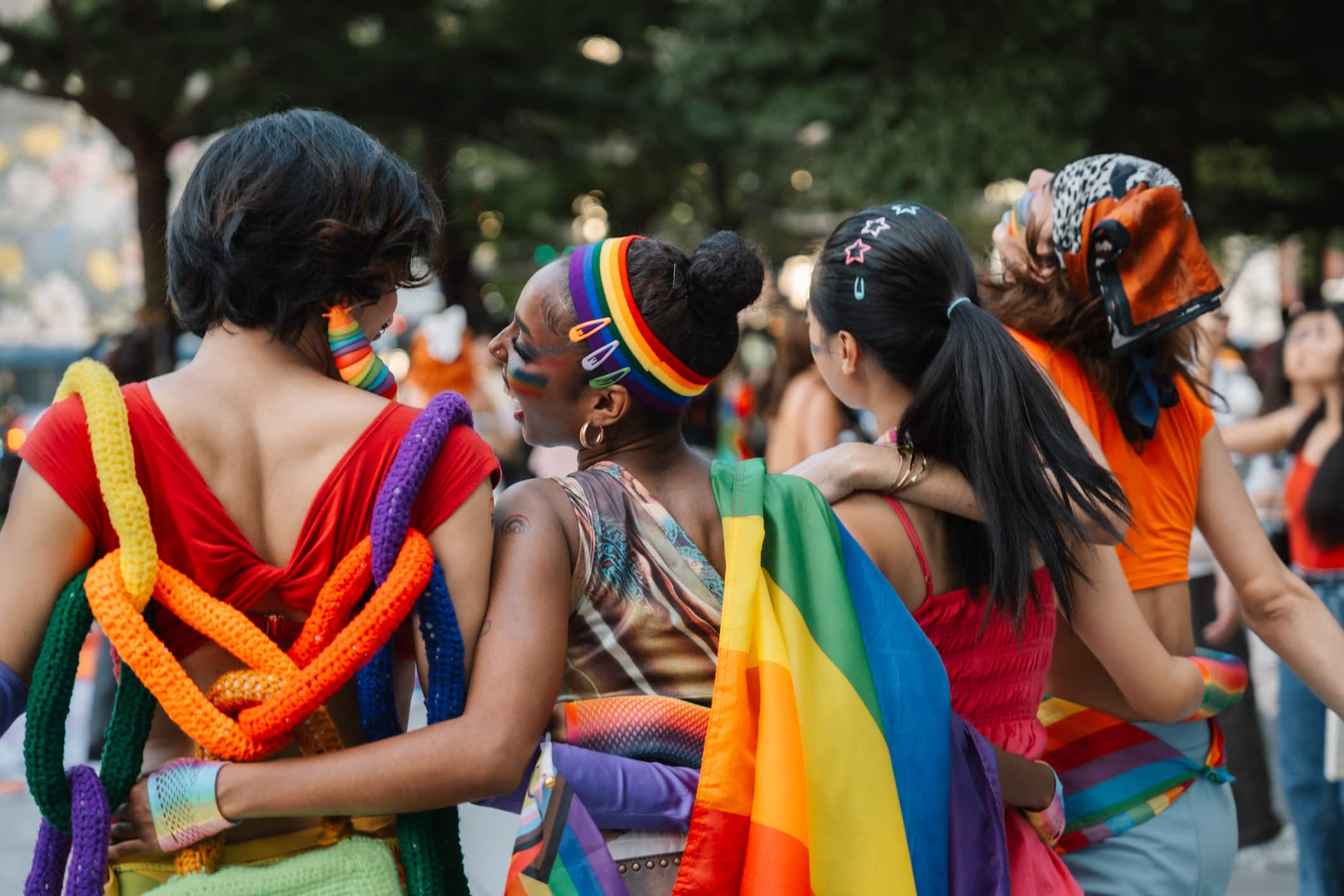 A group of young Asian LGBTQ friends enjoys the excitement of Bangkok Pride parade, taking a photo together to cherish their bond, express self-love, and celebrate their identity in a welcoming space.
