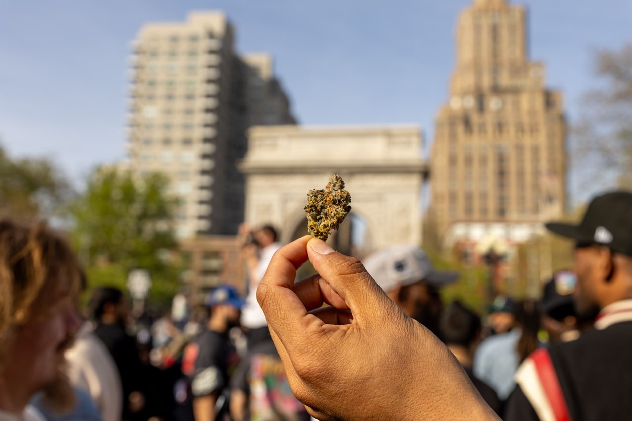 New York, United States – April 21, 2025: The 420 celebration on April 20, 2025, in Washington Square Park captures a hand holding a nug of cannabis, against the Washington Square Arch